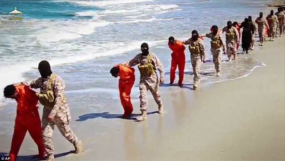 Thirty Ethiopian Christians appear to have been beheaded and shot by ISIS in a sickening new propaganda video. Above, at least 16 men are marched down a beach in Libya by militants before they are killed