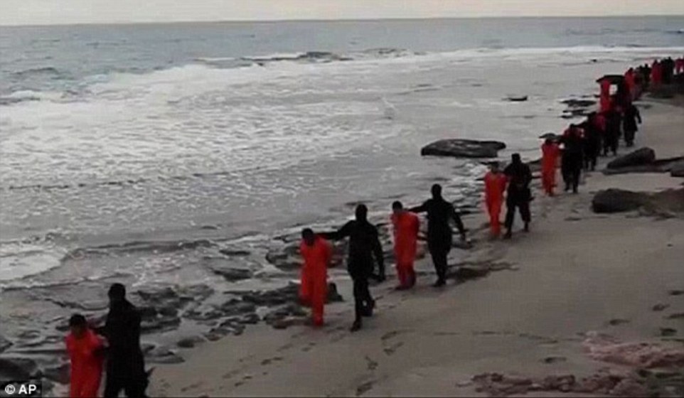 The latest video mirrored a film released in February showing militants beheading 21 captured Egyptian Christians on a Libyan beach (pictured above), which immediately drew Egyptian airstrikes on the group's suspected positions in Libya
